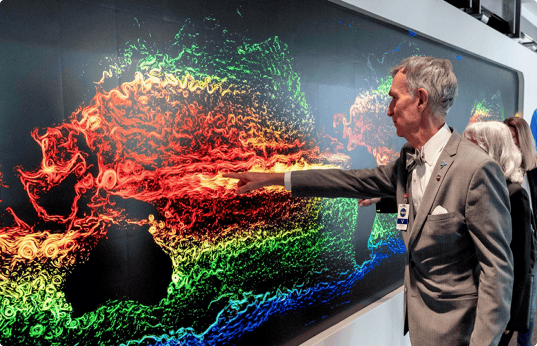 Bill Nye interacting with The Earth Information Center's Hyperwall at NASA HQ.