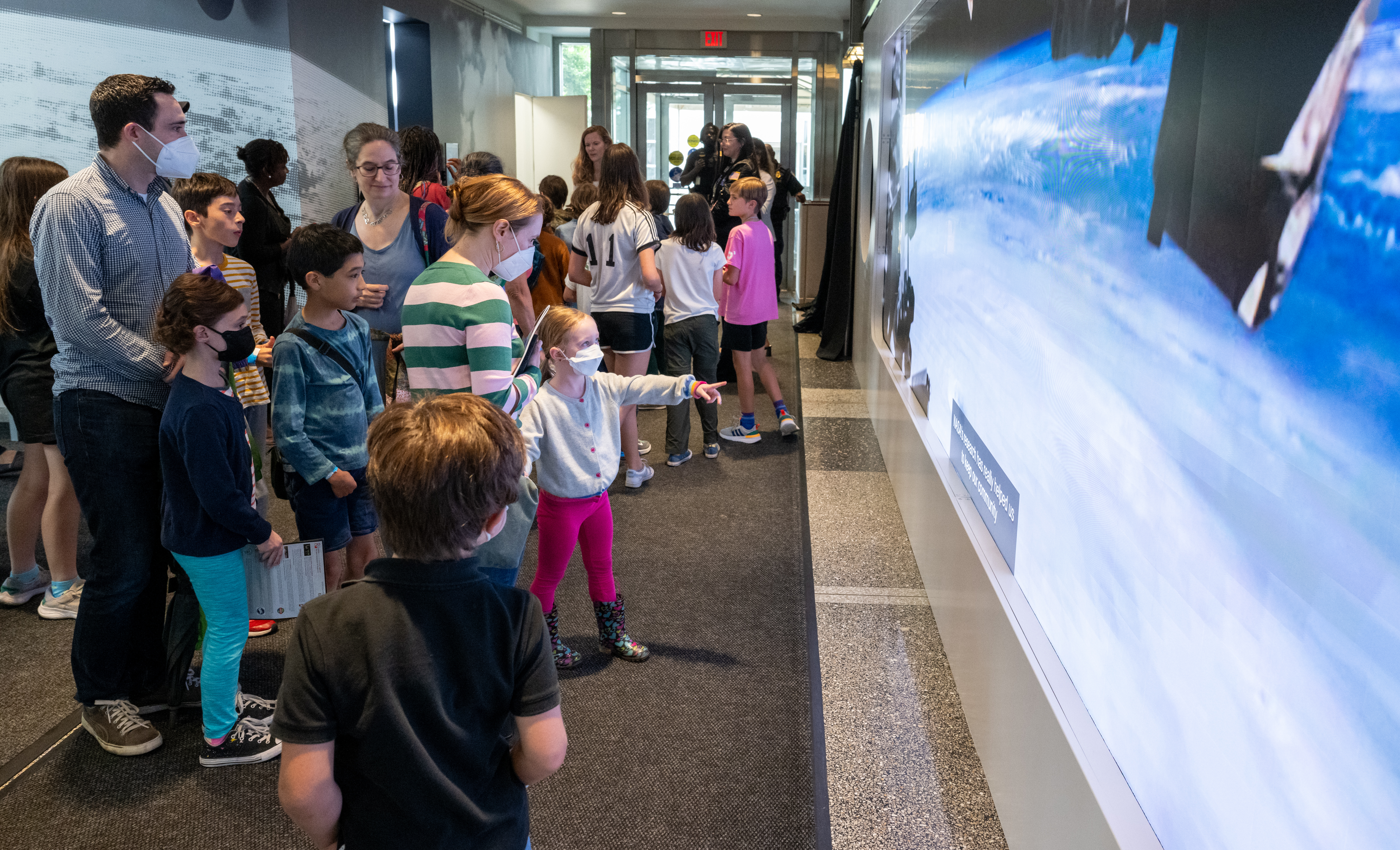 Children learning about Earth science through The Earth Information Center's display.