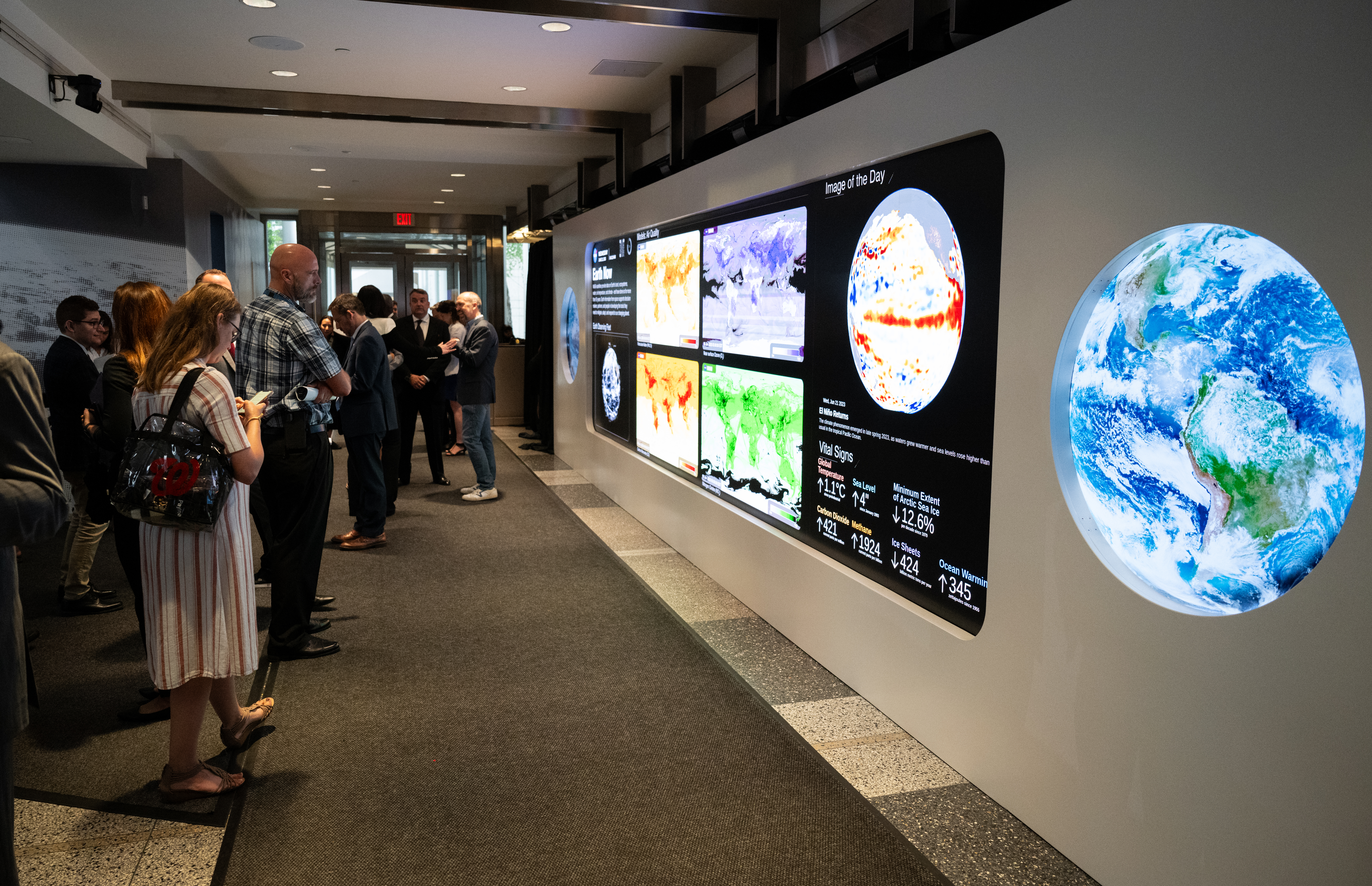 Guests to NASA HQ observing The Earth Information Center's Hyperwall.