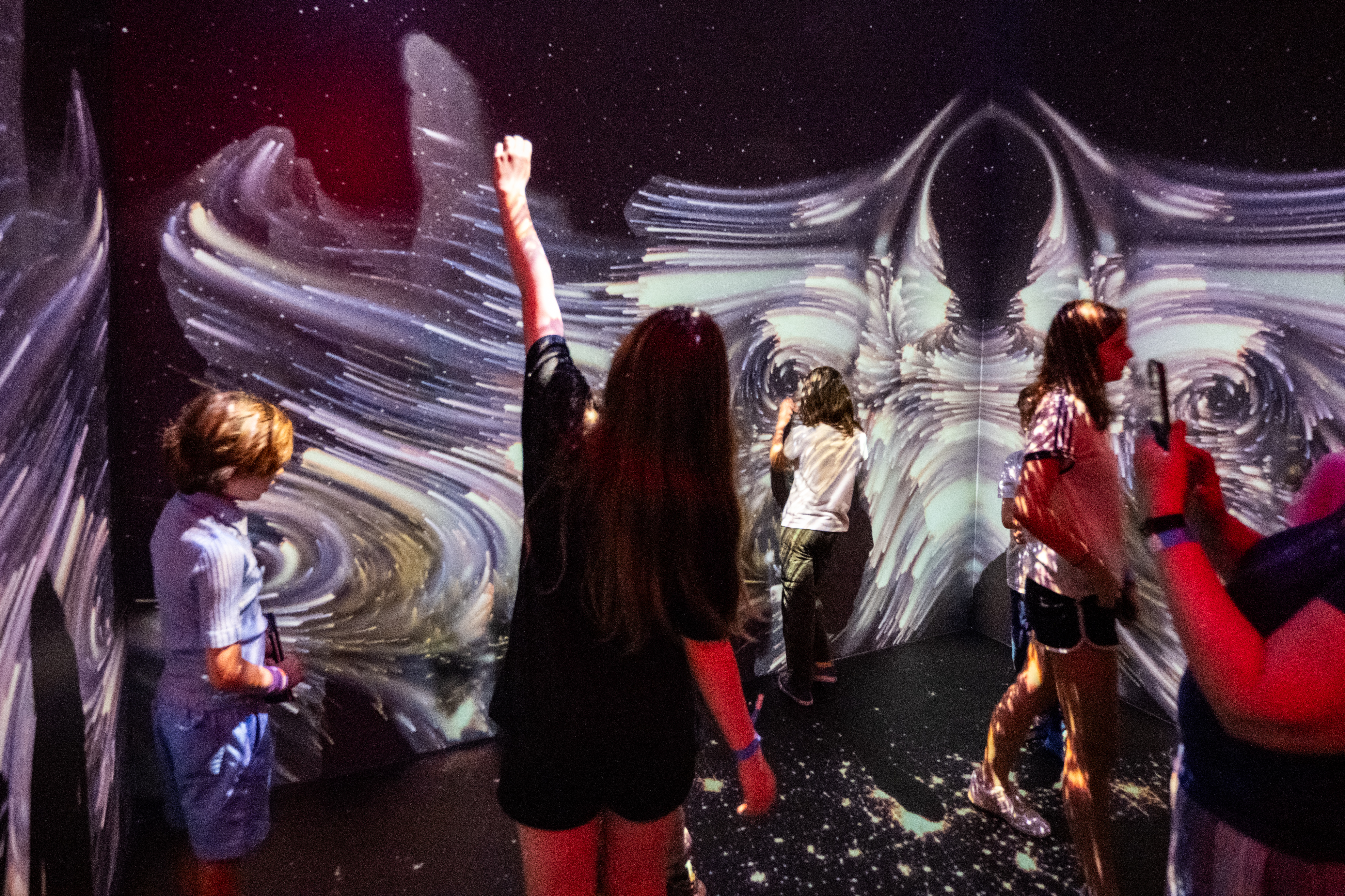 Guests at NASA HQ exploring Space for Earth's immersive experience.