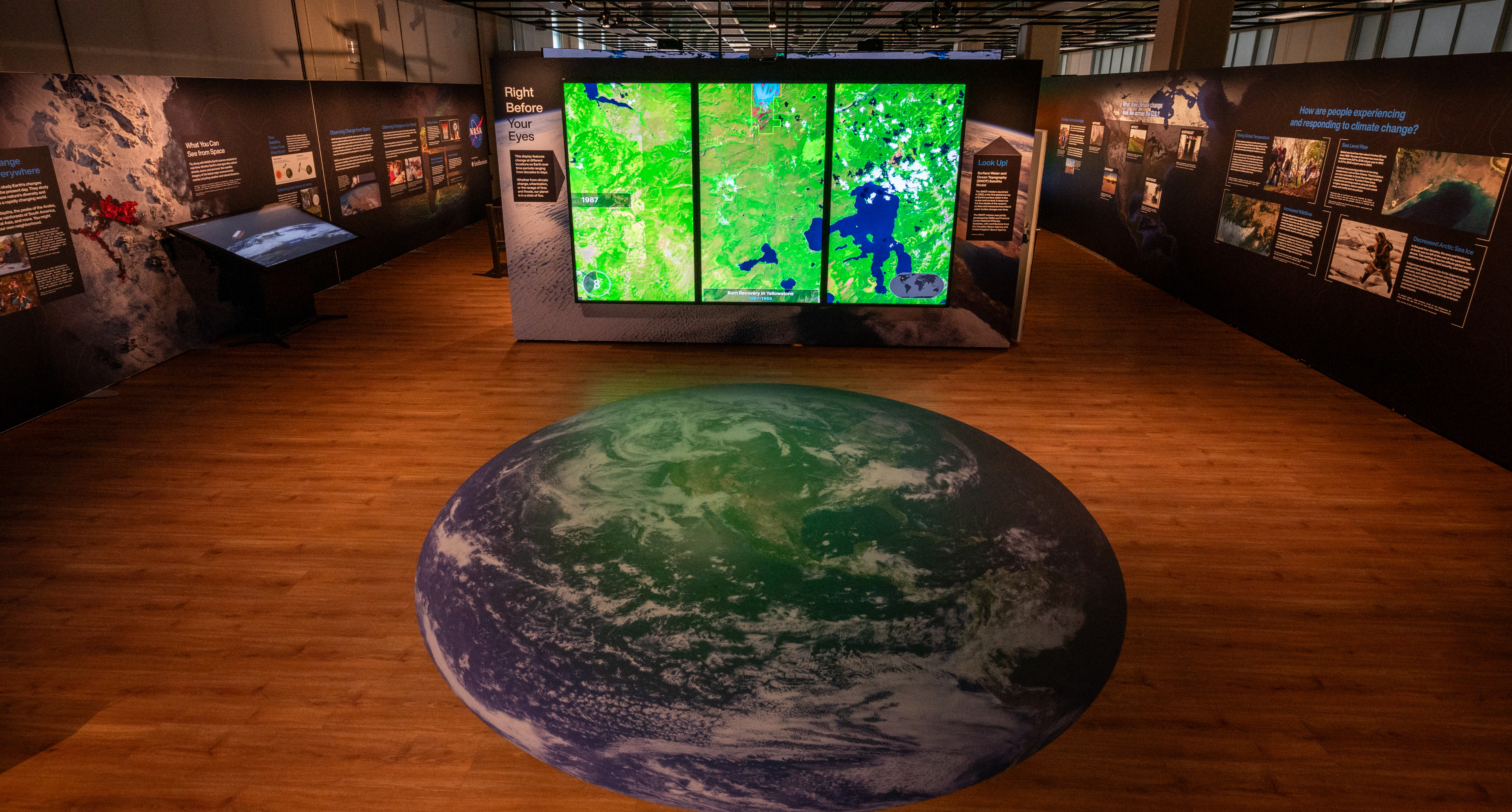 NASA's Time Unveiled exhibit from a high vantage point, showing a globe image on the floor.
